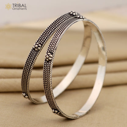 Sterling silver custom-designed bangle bracelet by TRIBAL ORNAMENTS featuring intricate tribal patterns, perfect for gifting or brides.