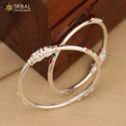 Sterling silver baby bangle bracelet with ball design by TRIBAL ORNAMENTS, showcasing a sleek, polished silver jewelry piece for infants.