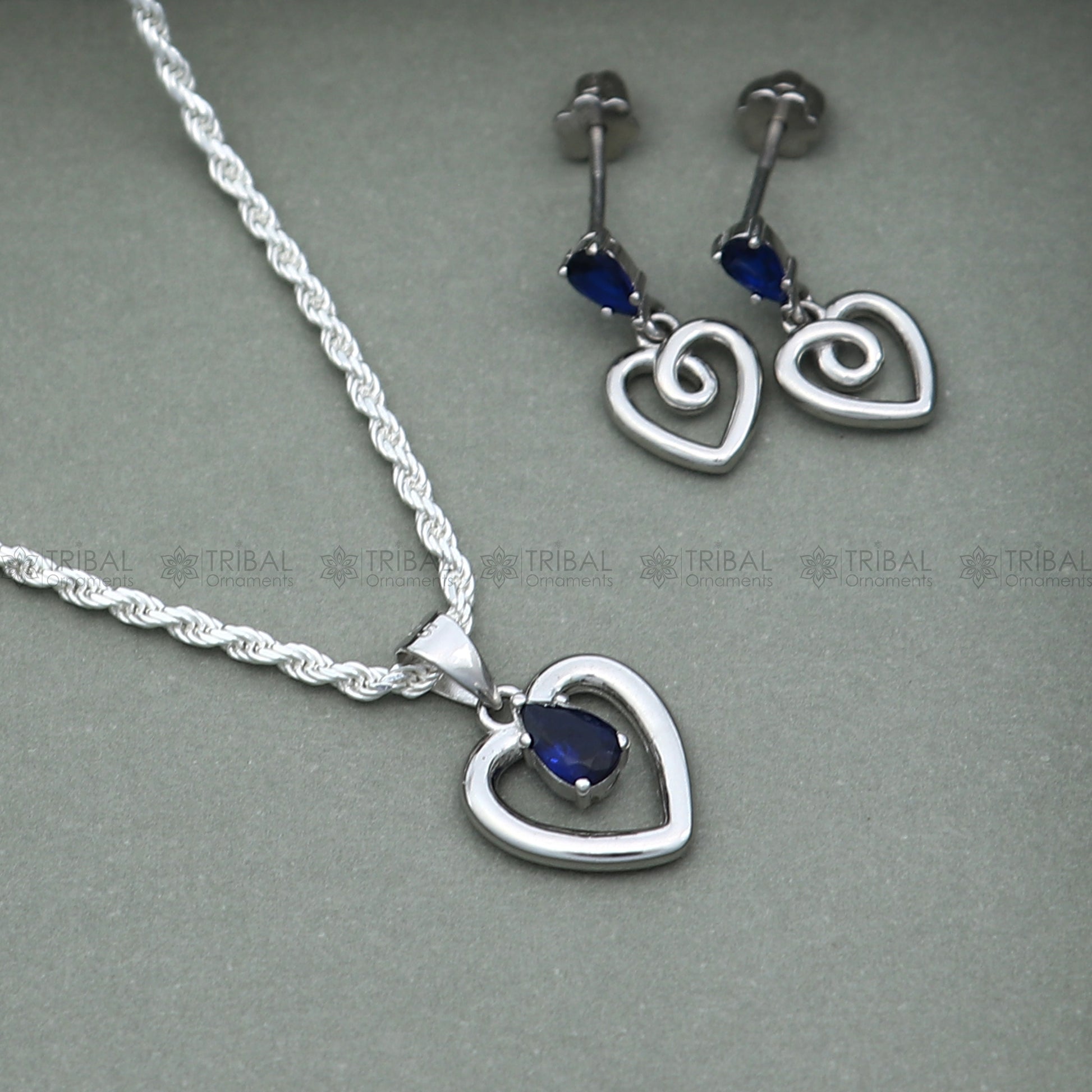 Sterling silver blue sapphire heart-shaped pendant set with sparkling diamonds, elegant jewelry by TRIBAL ORNAMENTS.