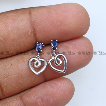 Sterling silver blue sapphire heart-shaped pendant set by Tribal Ornaments, featuring a sparkling blue diamond detail.