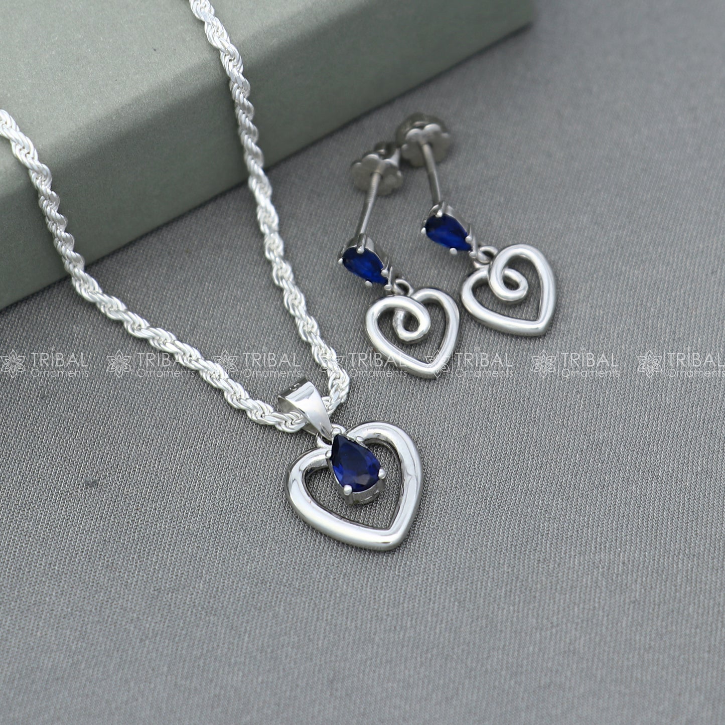 Sterling silver blue sapphire heart-shaped pendant set with matching earrings, crafted by TRIBAL ORNAMENTS.