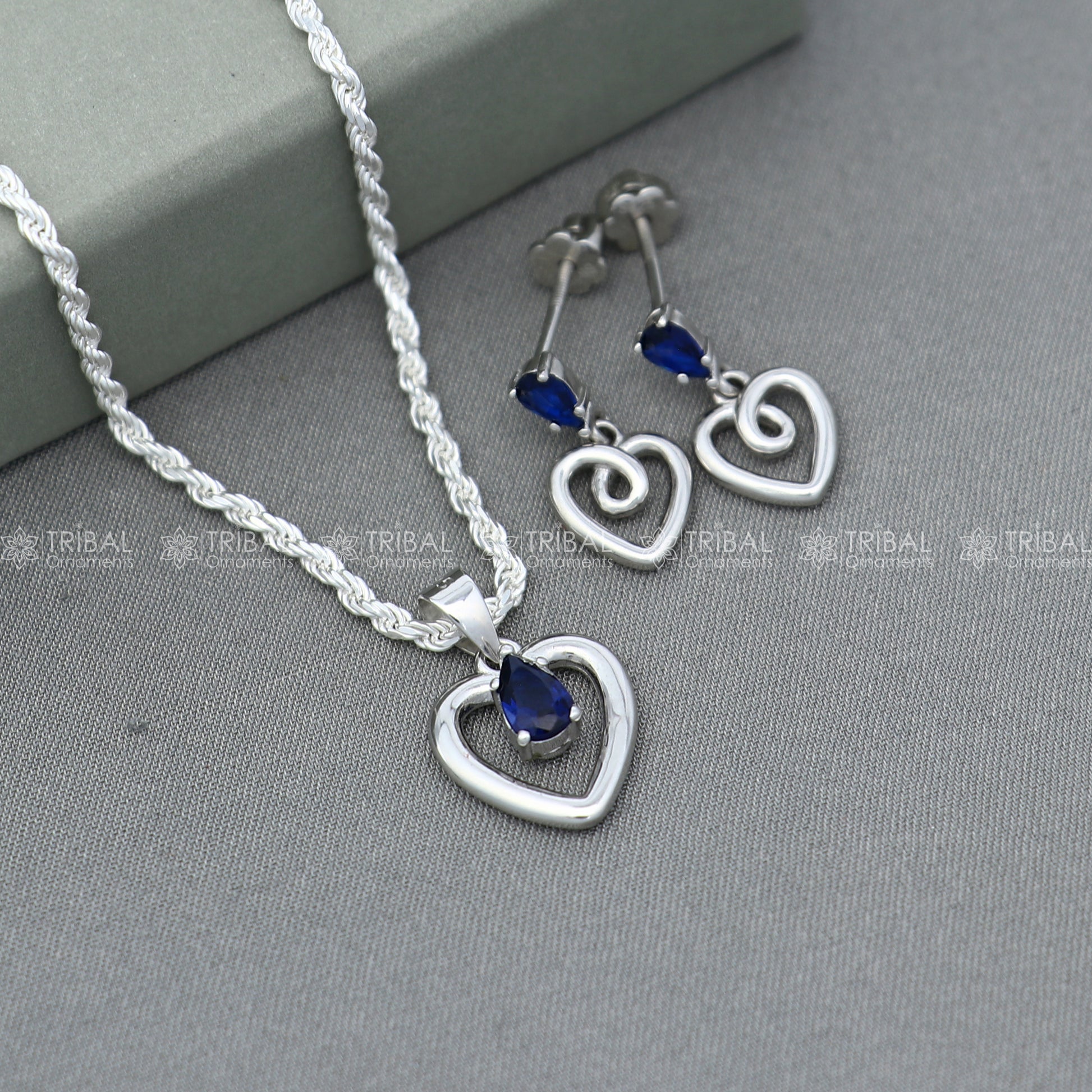 Sterling silver blue sapphire heart-shaped pendant set with matching earrings, crafted by TRIBAL ORNAMENTS.