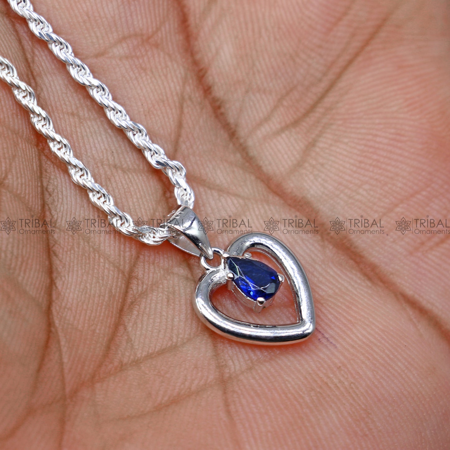 925 Sterling silver blue sapphire heart-shaped pendant set by Tribal Ornaments, featuring sparkling blue diamond accents.