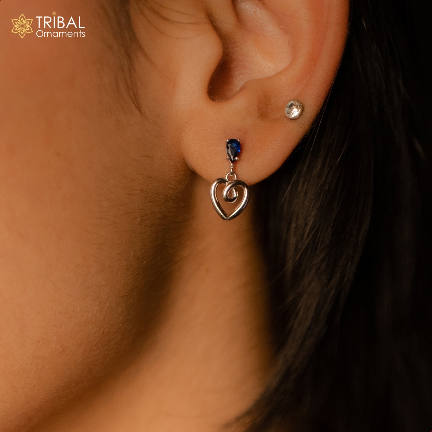 925 Sterling silver pendant set with blue sapphire heart-shaped charm, featuring sparkling blue diamonds and intricate tribal design.