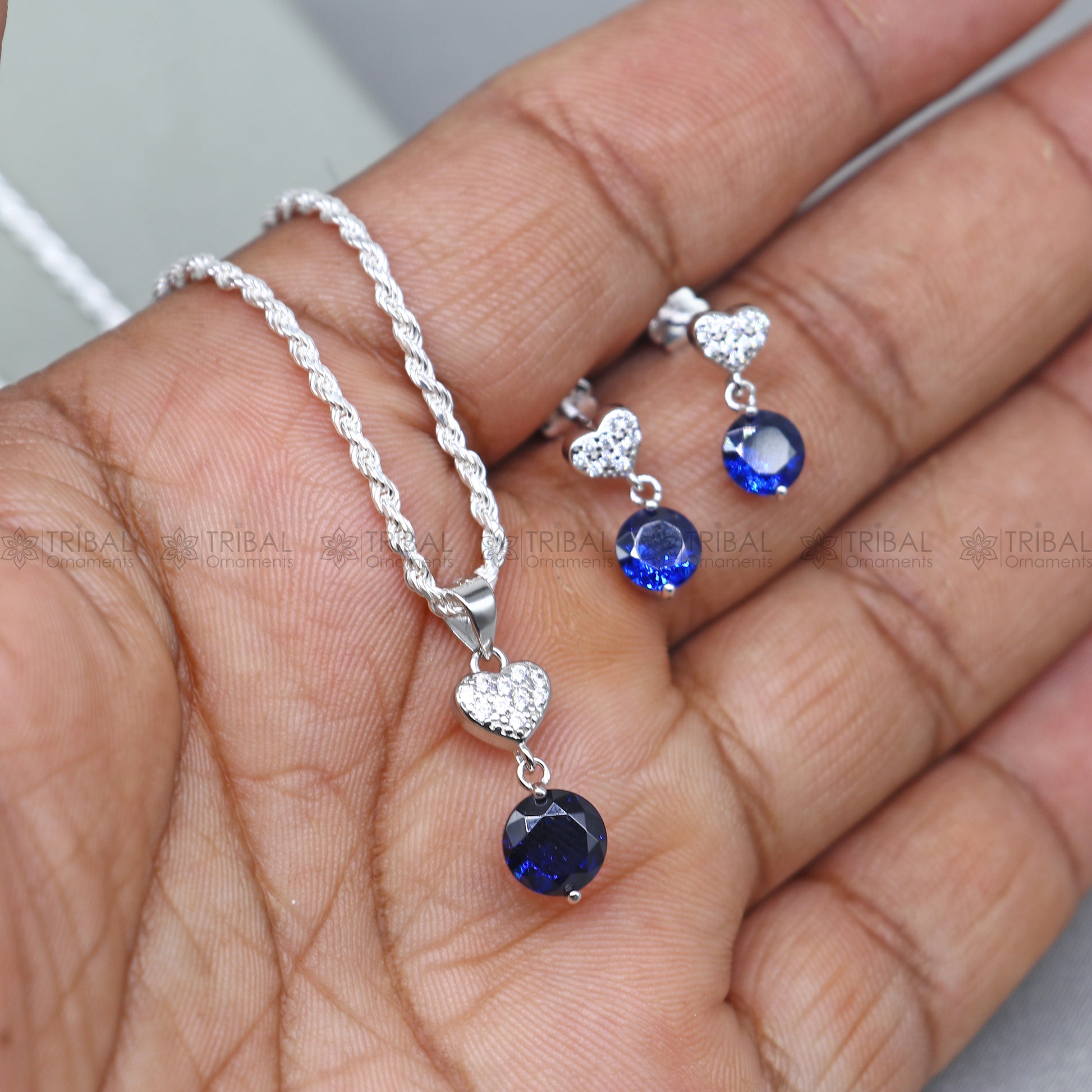 Sterling silver pendant set with round blue sapphire diamond from Tribal Ornaments, showcasing a elegant jewelry design.