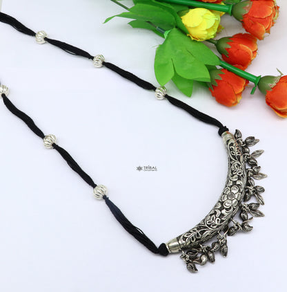 Sterling silver customized modern tribal charm necklace with intricate chitai and kandrai work, paired with delicate jewelry set.