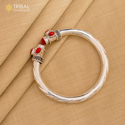 Unisex 925 sterling silver tribal bangle bracelet with a customized red stone, featuring traditional cuff design by Tribal Ornaments.