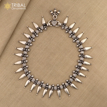 Sterling silver ankle bracelet with dangling bell charms from TRIBAL ORNAMENTS, featuring attractive bells for trendy foot jewelry.