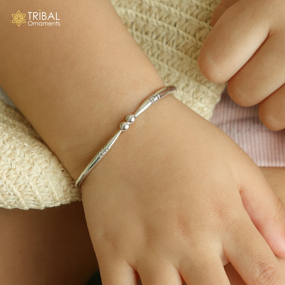 925 sterling silver baby bangle bracelet with a plain bright design, adjustable for newborns, from TRIBAL ORNAMENTS.