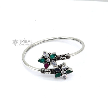 Sterling silver cuff bangle bracelet with red and green cut stones, tribal design by TRIBAL ORNAMENTS.