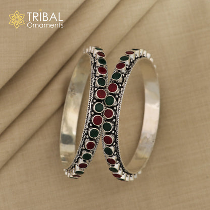Sterling silver bangle bracelet with vibrant green and red stones, elegant jewelry piece for women by Tribal Ornaments.