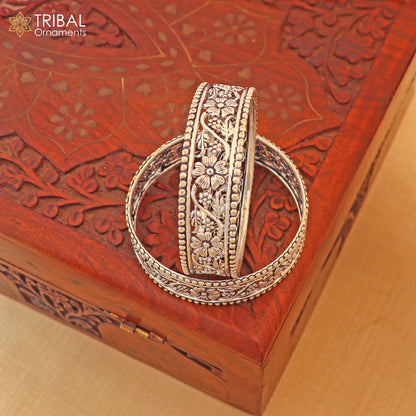 Sterling silver floral design customized bangle kada jewelry by TRIBAL ORNAMENTS, showcasing intricate floral patterns and craftsmanship.
