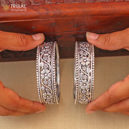 Sterling silver floral design bangle, customized tribal jewelry by TRIBAL ORNAMENTS, featuring intricate floral patterns.
