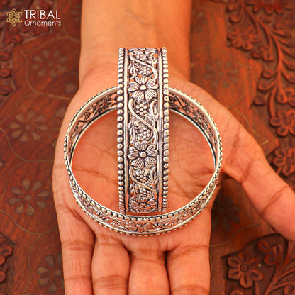 Sterling silver floral design customized bangle kada jewelry by TRIBAL ORNAMENTS, showcasing intricate floral patterns.