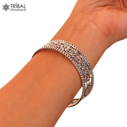 Sterling silver floral design customized bangle or kada jewelry by TRIBAL ORNAMENTS, showcasing intricate floral patterns.