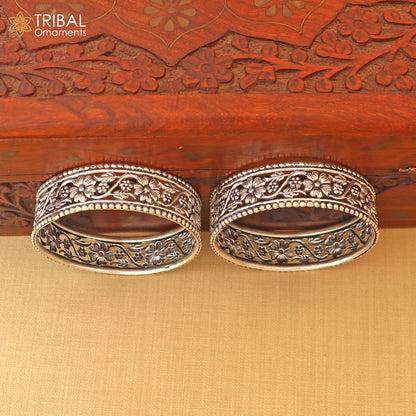 Sterling silver floral design bangle Kada jewelry by TRIBAL ORNAMENTS with intricate floral patterns and custom details.