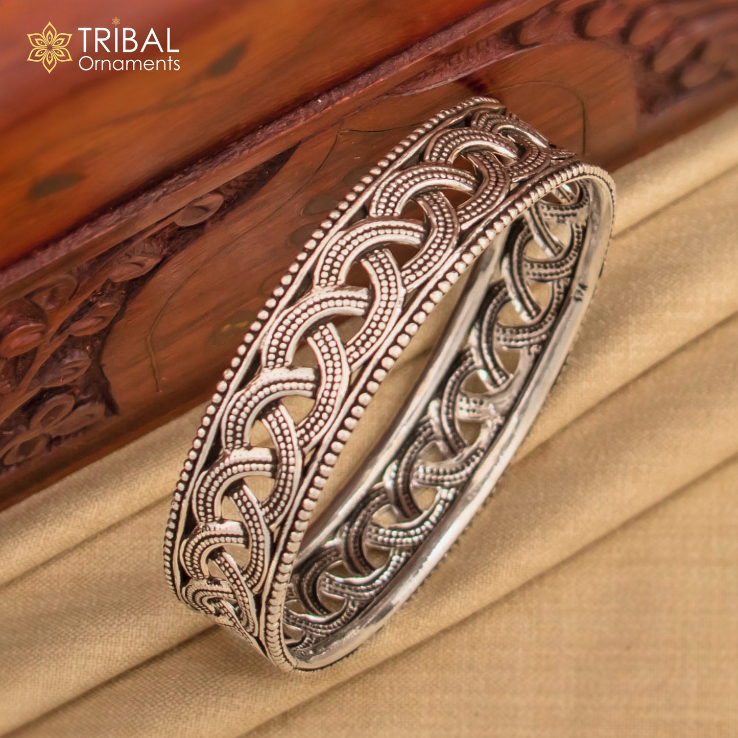 Sterling silver flower design bangle bracelet from TRIBAL ORNAMENTS' bridal wedding jewelry collection, featuring intricate floral details.