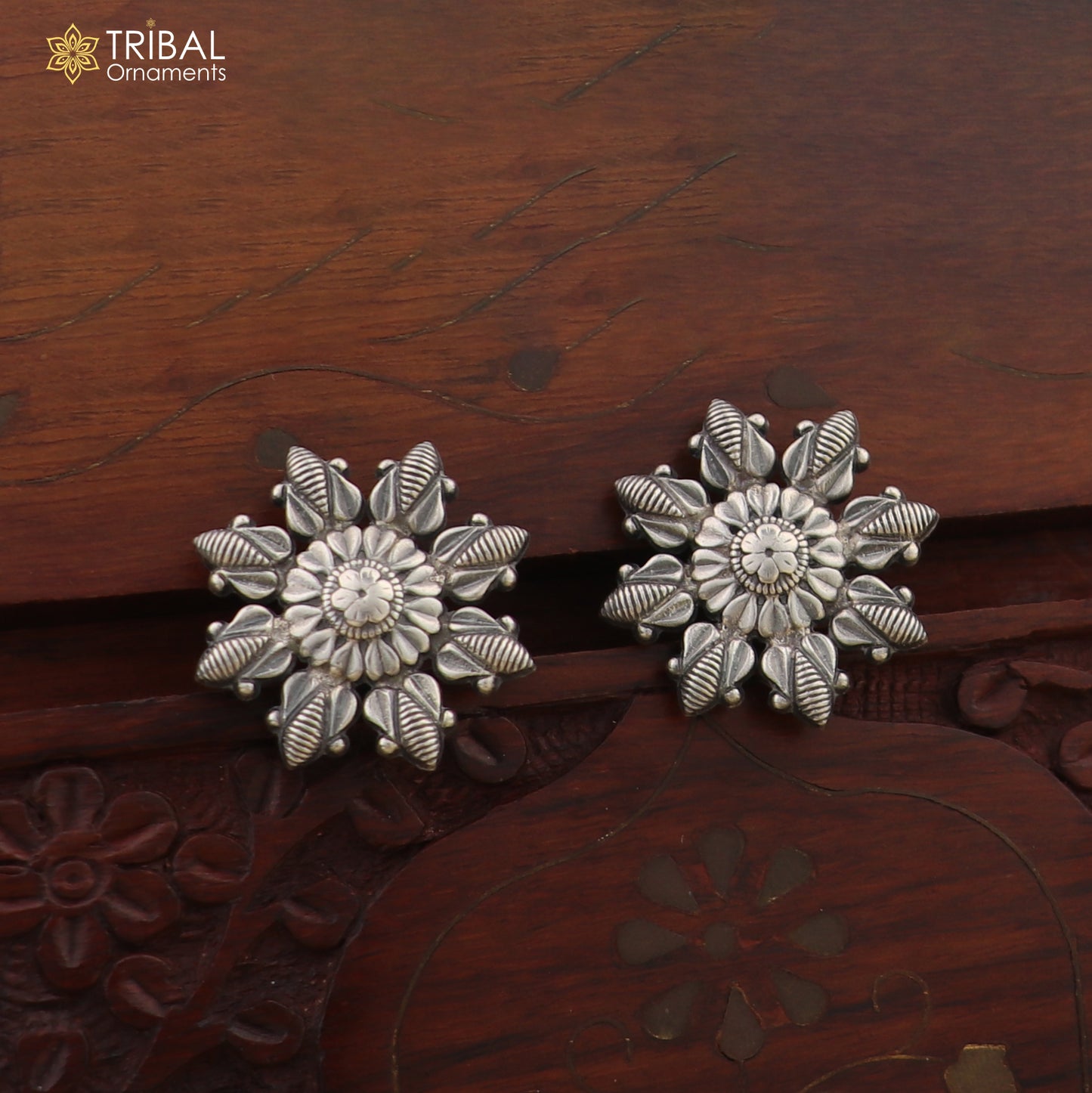 Sterling silver flower design stud earring by TRIBAL ORNAMENTS, stylish jewelry accessory with intricate floral pattern.
