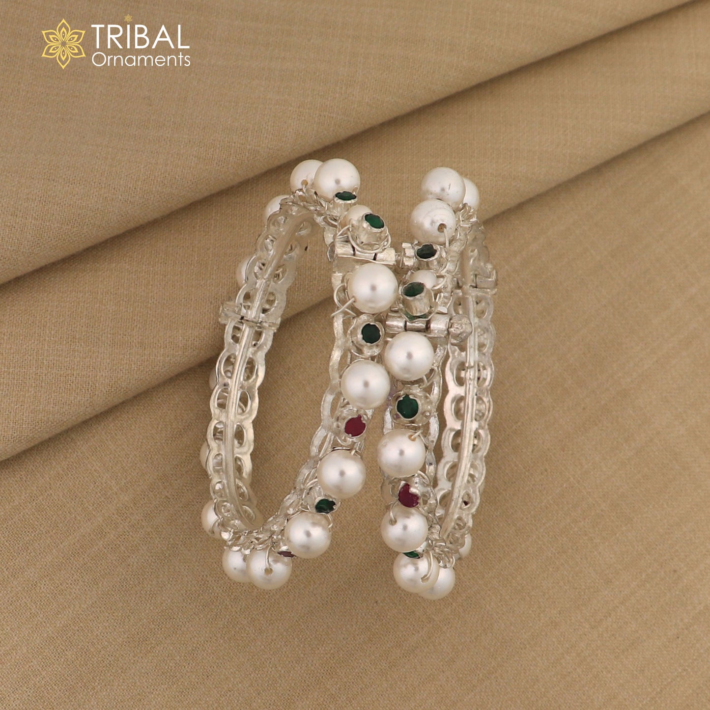 Sterling silver tribal bangle with pearl beads, featuring intricate design and customizable details in traditional tribal jewelry style.