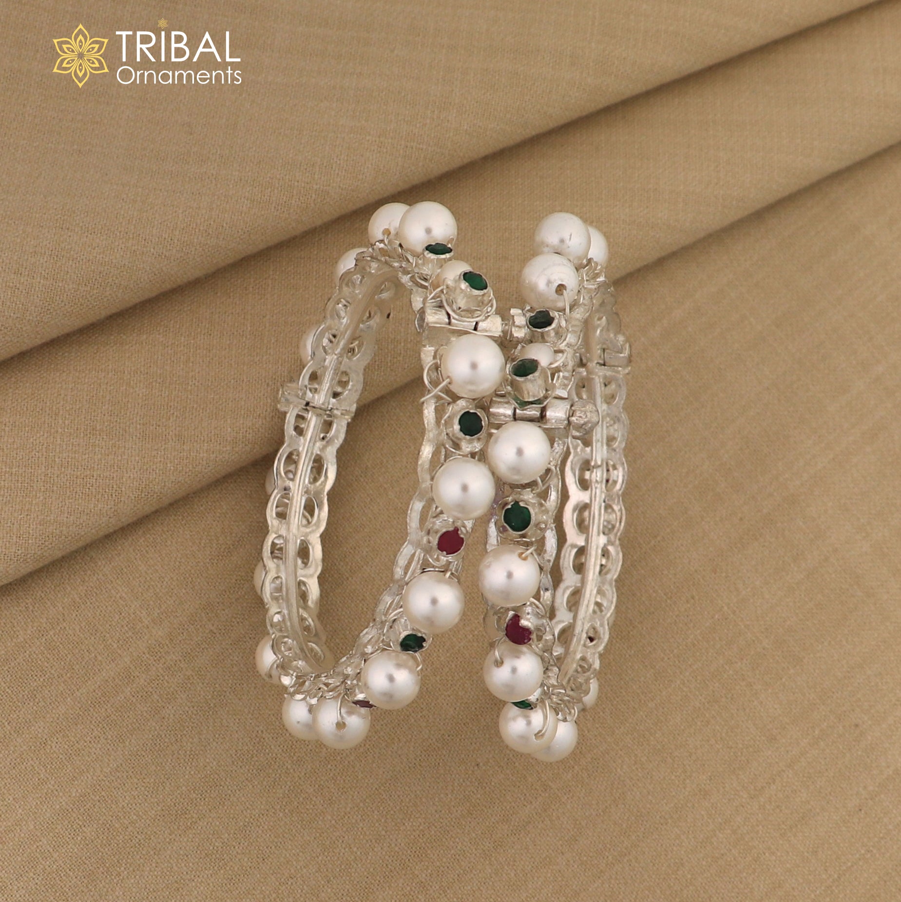 Sterling silver tribal bangle with pearl beads, featuring intricate design and customizable details in traditional tribal jewelry style.