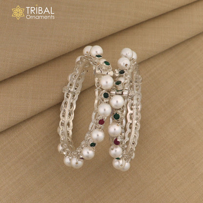 Sterling silver tribal bangle with pearl beads, featuring intricate design and customizable details in traditional tribal jewelry style.