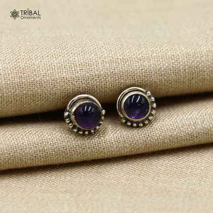 Sterling silver round amethyst stud earring from TRIBAL ORNAMENTS, unisex jewelry with vibrant purple gemstone.