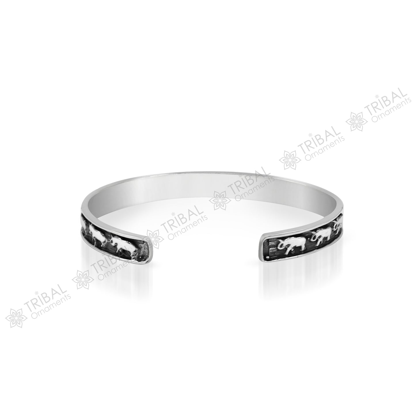 Sterling silver elephant design bangle cuff bracelet by TRIBAL ORNAMENTS, featuring a waved open-face detail, unisex jewelry accessory.