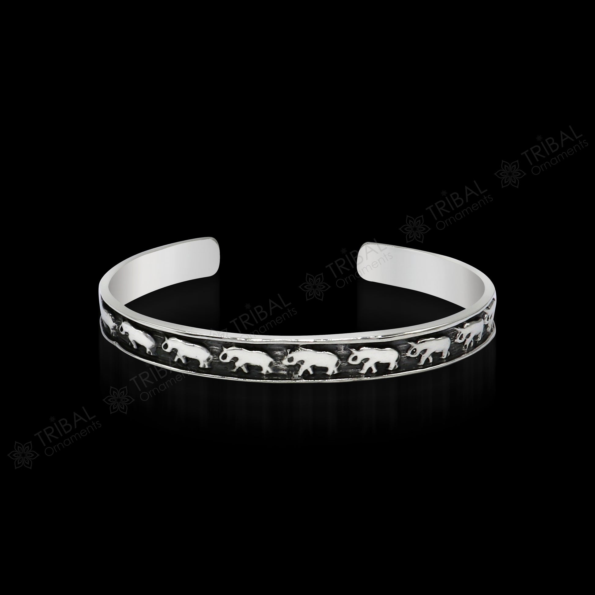 Sterling silver elephant design cuff bracelet by Tribal Ornaments, featuring a waved open-face bangle, perfect for gifting or unisex wear.