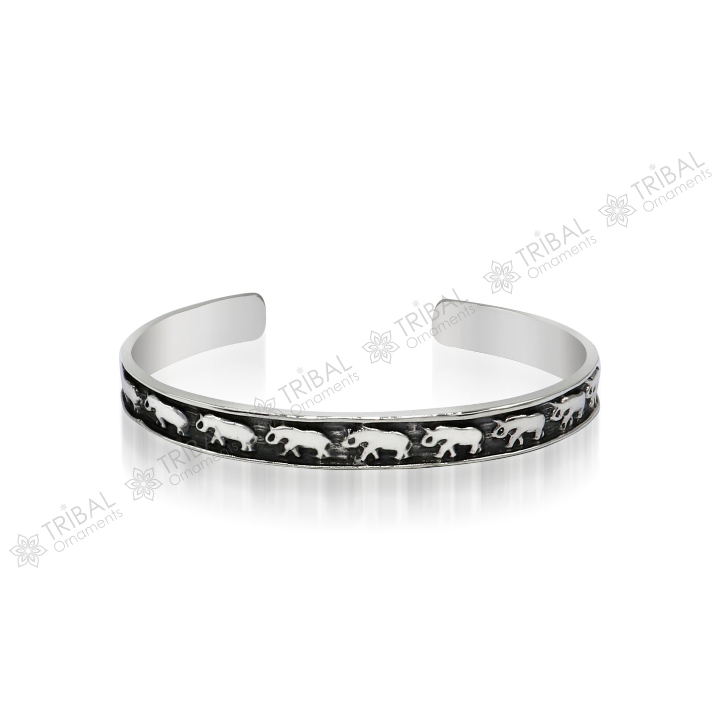 Sterling silver elephant design bangle cuff bracelet from TRIBAL ORNAMENTS, featuring a waved open-face design, unisex jewelry.