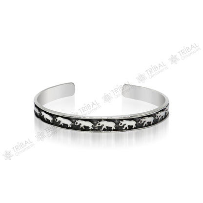 Sterling silver elephant design bangle cuff bracelet from TRIBAL ORNAMENTS, featuring a waved open-face design, unisex jewelry.