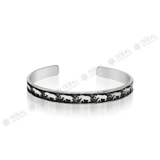 Sterling silver elephant design bangle cuff bracelet from TRIBAL ORNAMENTS, featuring a waved open-face design, unisex jewelry.