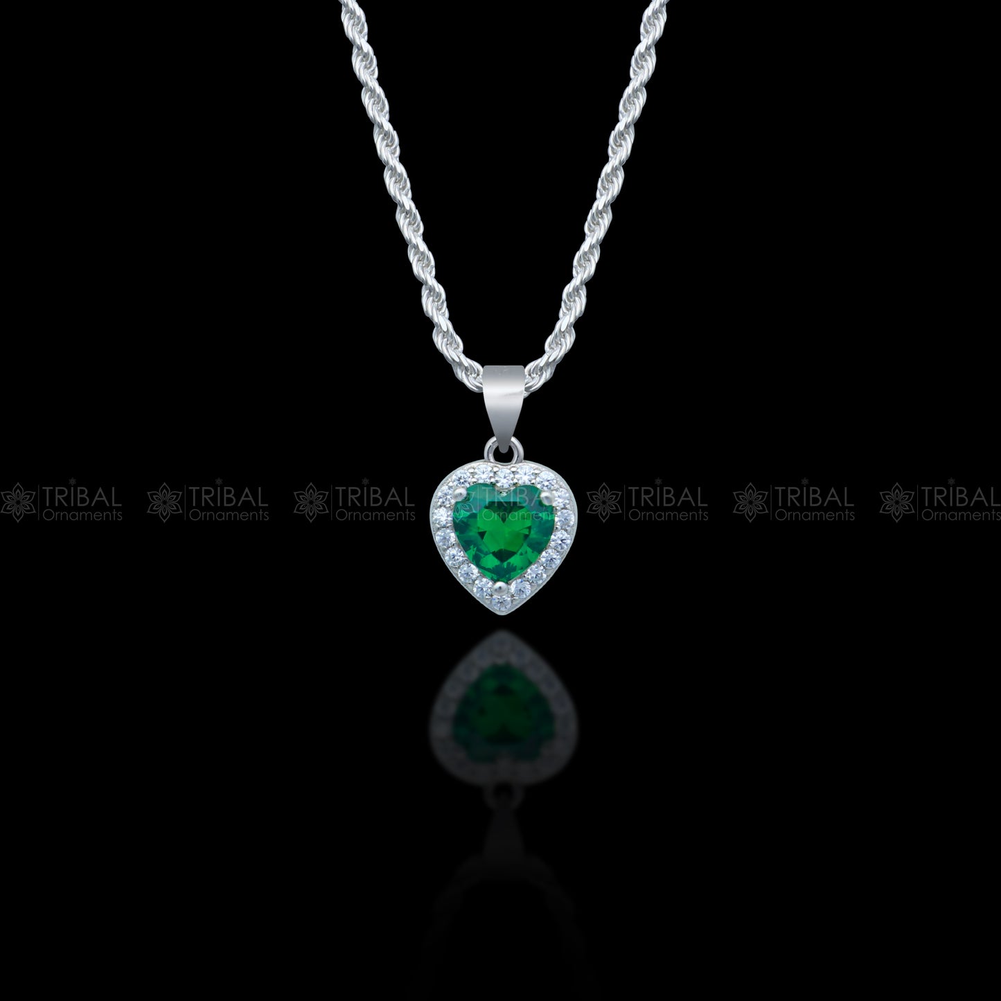 925 Sterling silver heart-shaped pendant set with green emerald diamonds, featuring intricate tribal ornament design.