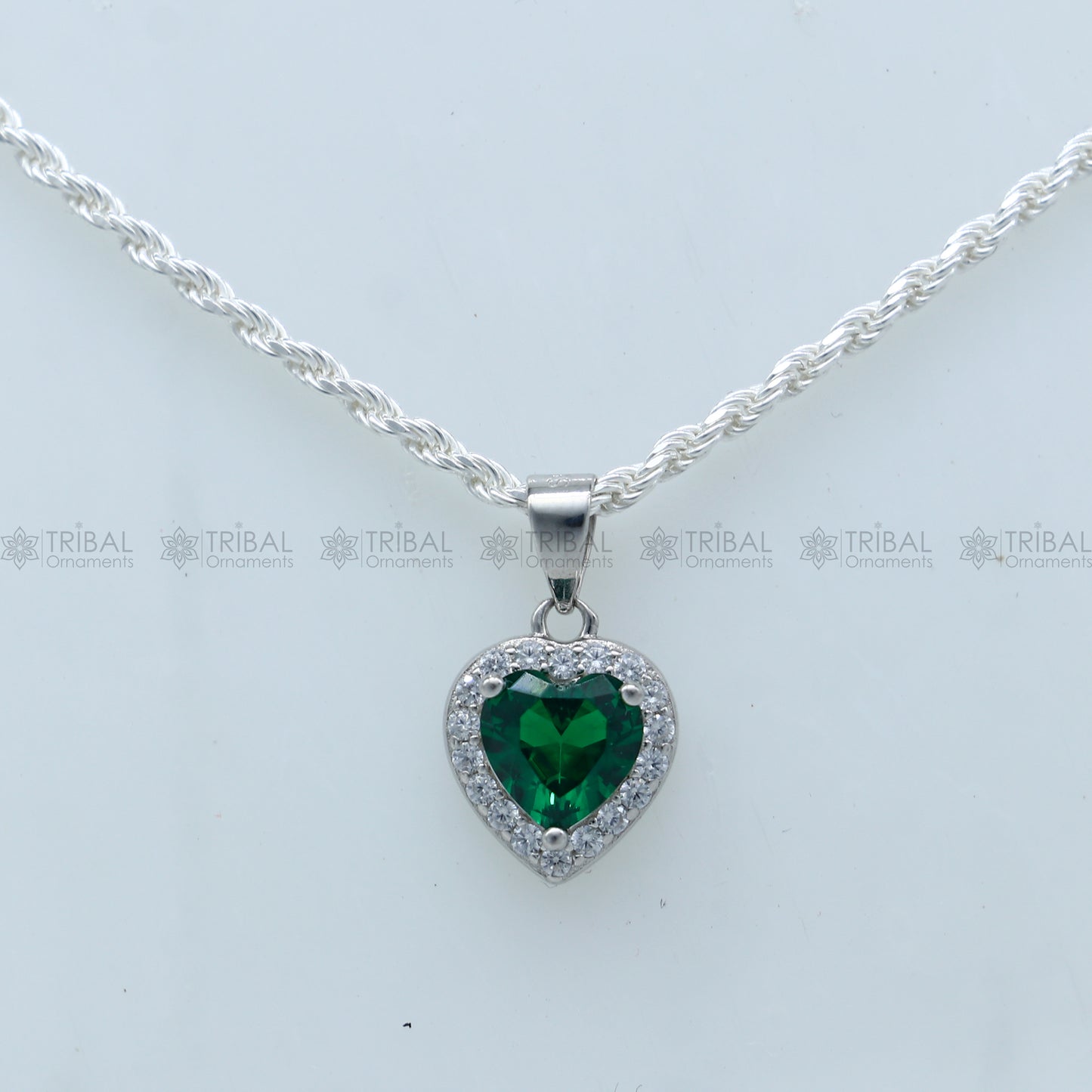 925 Sterling silver heart-shaped pendant set with green diamond (emerald) accents, featuring intricate tribal ornament design.