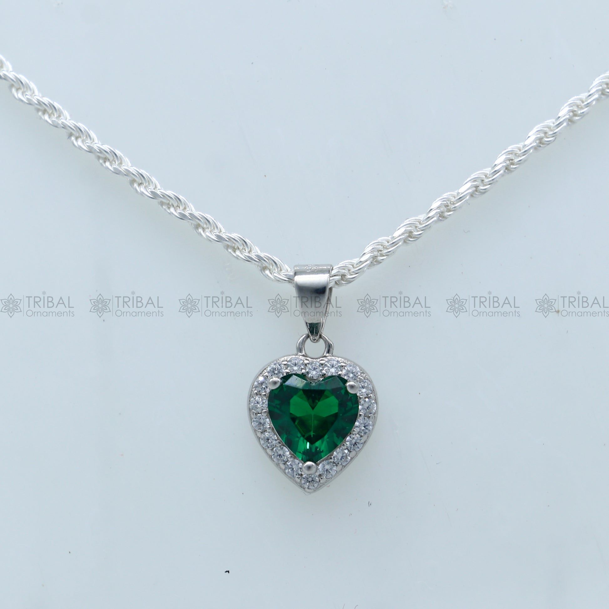925 Sterling silver heart-shaped pendant set with green diamond (emerald) accents, featuring intricate tribal ornament design.