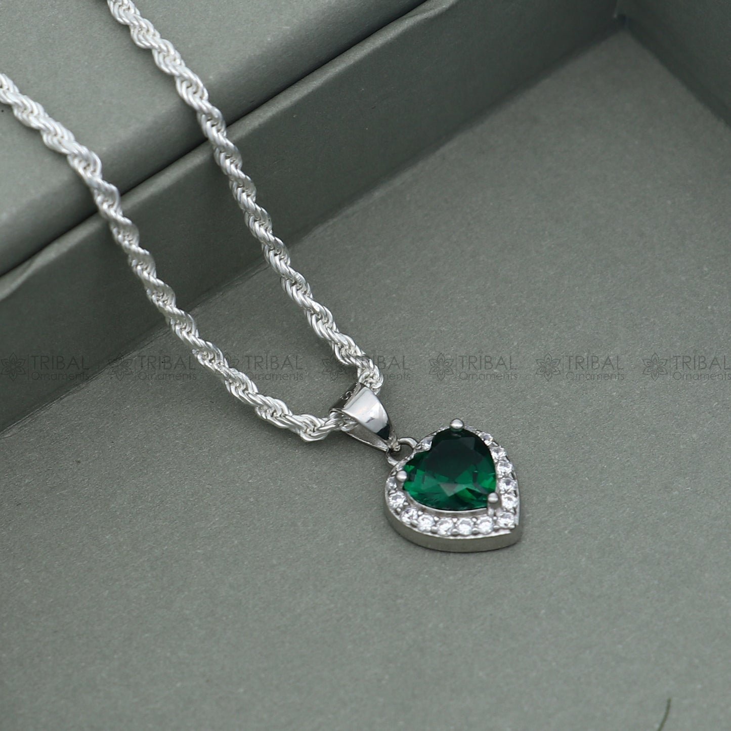 925 Sterling silver heart-shaped pendant set with green diamond (emerald) accents, featuring intricate tribal ornament design.