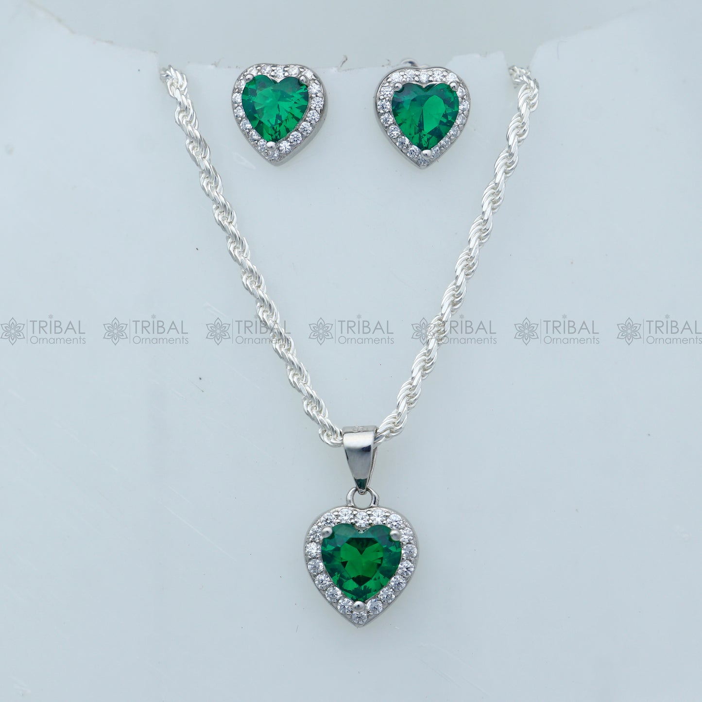 Sterling silver green diamond emerald heart-shaped pendant set by Tribal Ornaments, featuring intricate design and vibrant gemstone details.