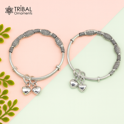 Sterling silver vintage baby bangle by TRIBAL ORNAMENTS with adjustable charm design, perfect for newborn kids jewelry.