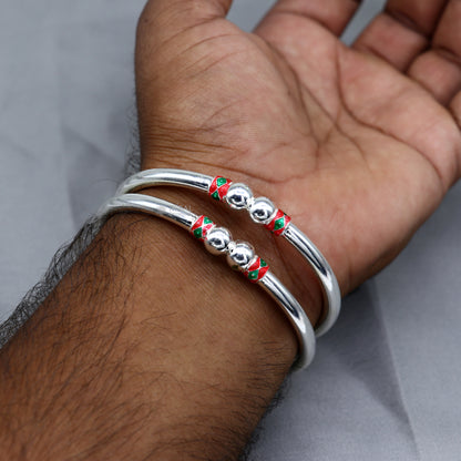 Sterling silver bangle bracelet with smooth ball design, handmade by Tribal Ornaments, showcasing a sleek, shiny finish.