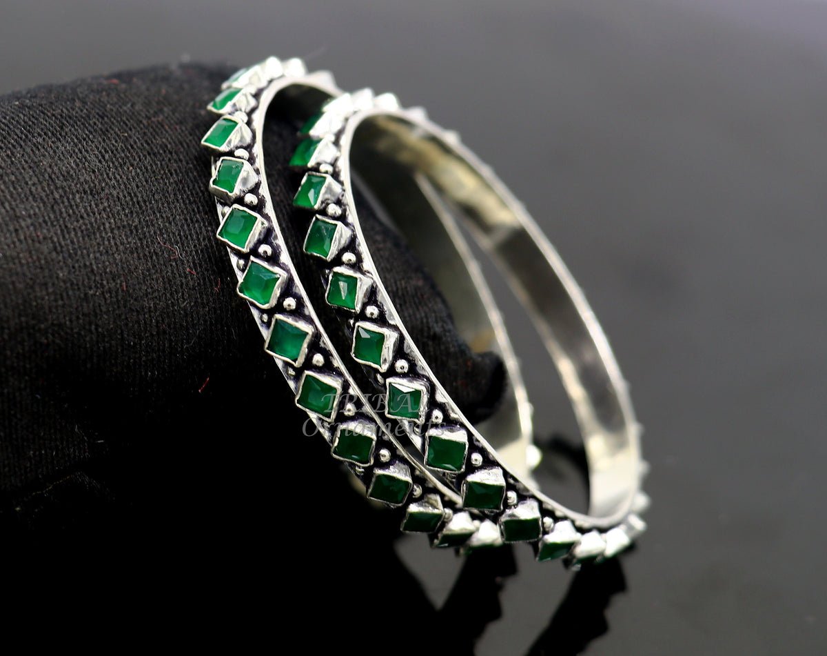 Handmade sterling silver tribal bangle bracelet with green stone, featuring fashionable ethnic design for women.