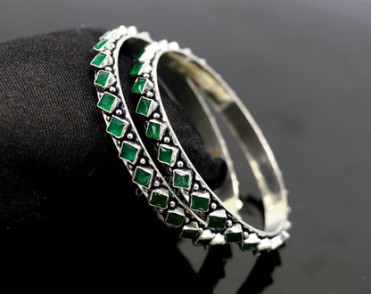 Handmade sterling silver tribal bangle bracelet with green stone, featuring fashionable ethnic design for women.