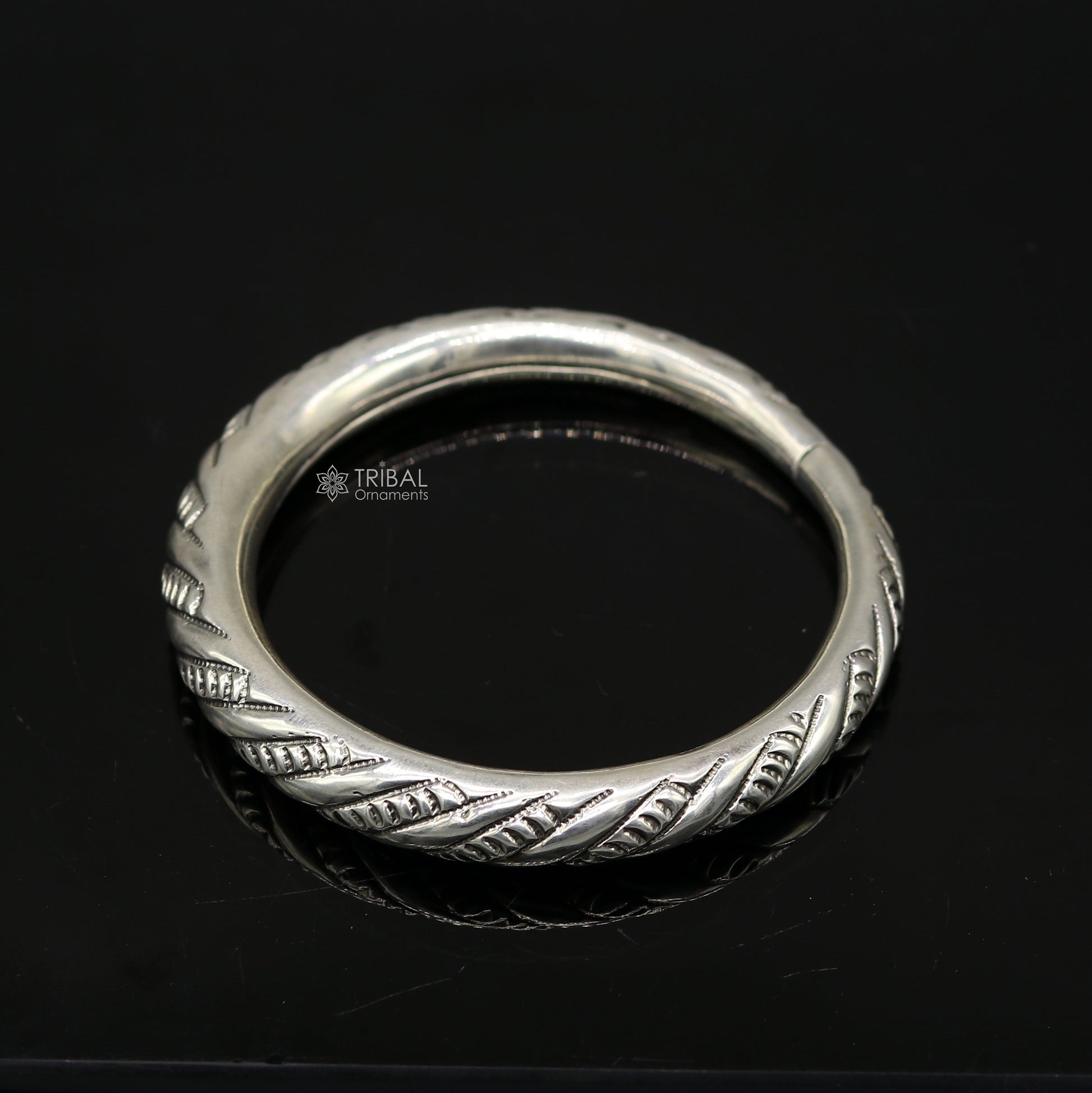 Unisex 925 sterling silver handmade heavy bangle bracelet with intricate tribal design from TRIBAL ORNAMENTS.