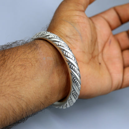 Unisex 925 sterling silver heavy bangle bracelet with intricate tribal design, handmade jewelry by TRIBAL ORNAMENTS.