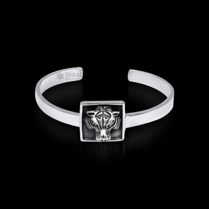 Sterling silver lion face design adjustable bangle cuff bracelet by TRIBAL ORNAMENTS, unisex ethnic jewelry with intricate detailing.