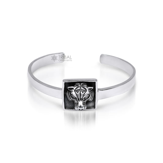 Sterling silver lion face design adjustable bangle cuff bracelet by TRIBAL ORNAMENTS, unisex ethnic jewelry with intricate craftsmanship.