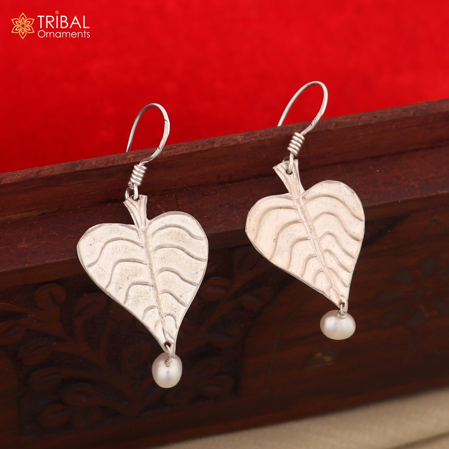 Sterling silver handmade peepal tree leaf earring with hanging pearl, featuring customized hoop design from TRIBAL ORNAMENTS summer collection.