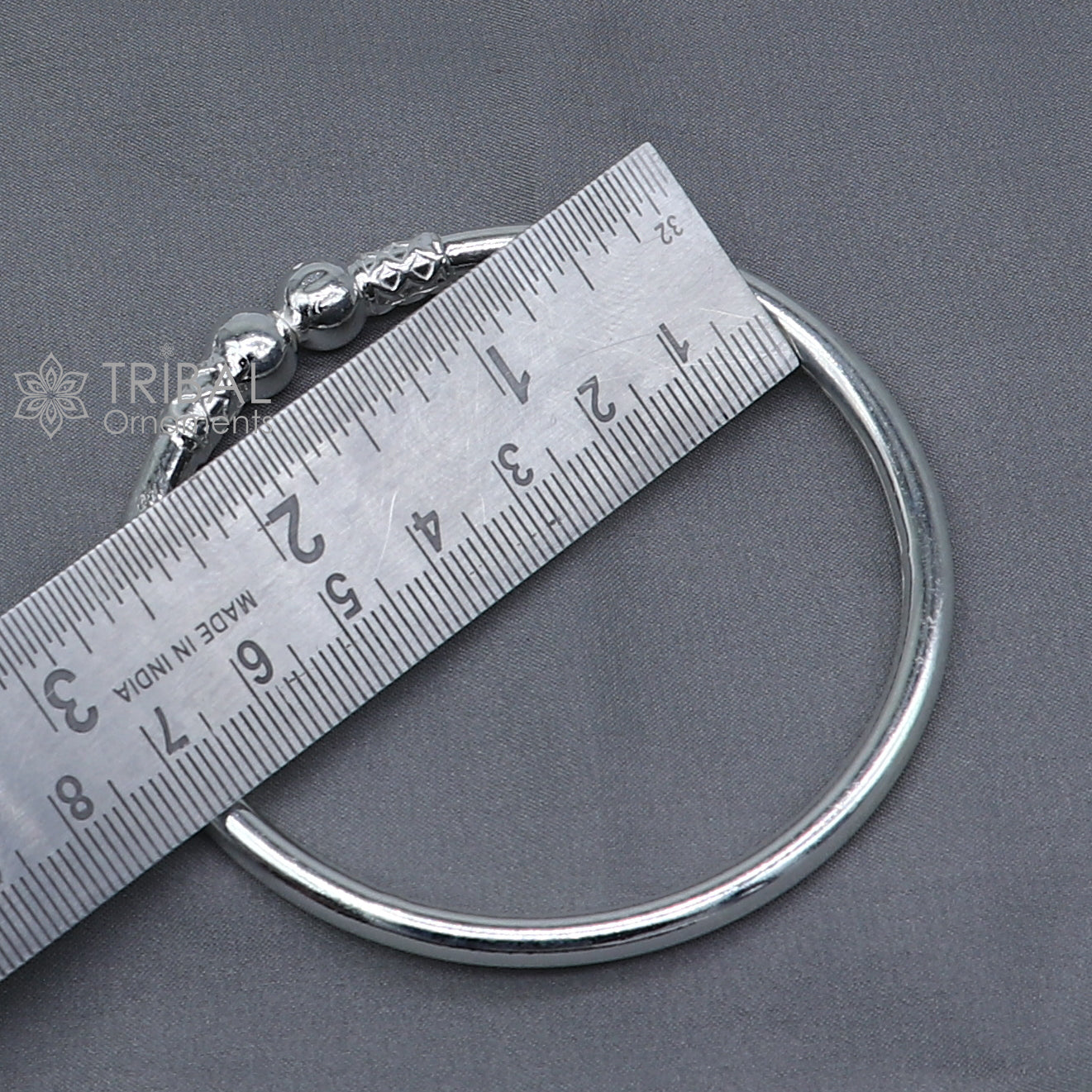 Sterling silver ball design bangle bracelet for girls, handmade tribal jewelry with a sleek, plain silver finish and round ball accents.