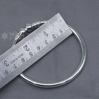 Sterling silver ball design bangle bracelet for girls, handmade tribal jewelry with a sleek, plain silver finish and round ball accents.