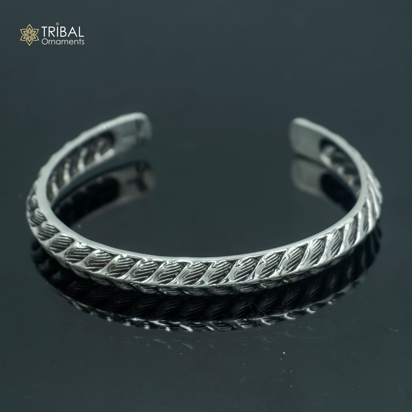 Sterling silver handmade adjustable stylish bangle bracelet by TRIBAL ORNAMENTS, unisex jewelry cuff with intricate design.