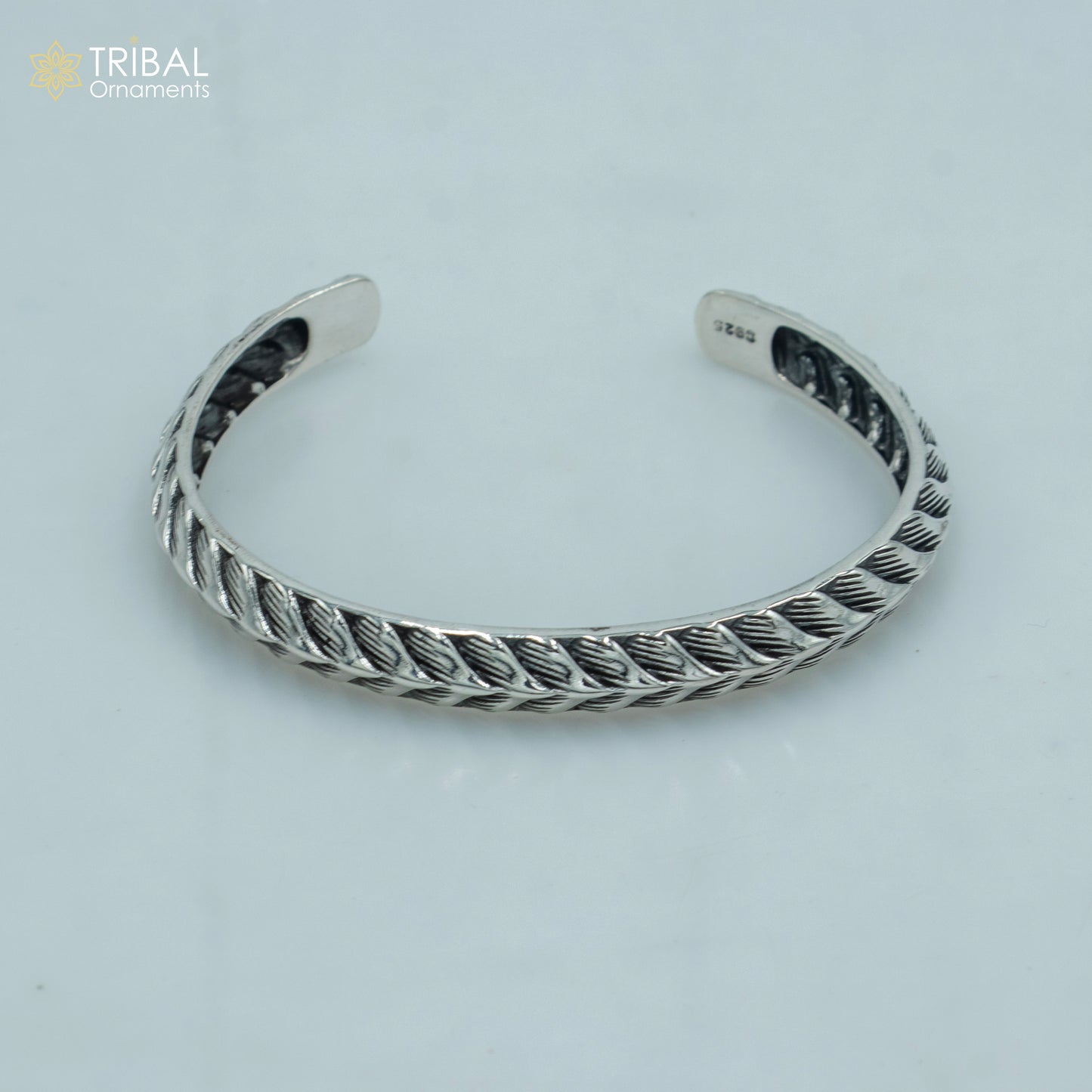 Sterling silver handmade adjustable bangle bracelet by TRIBAL ORNAMENTS, stylish unisex jewelry cuff with intricate design.