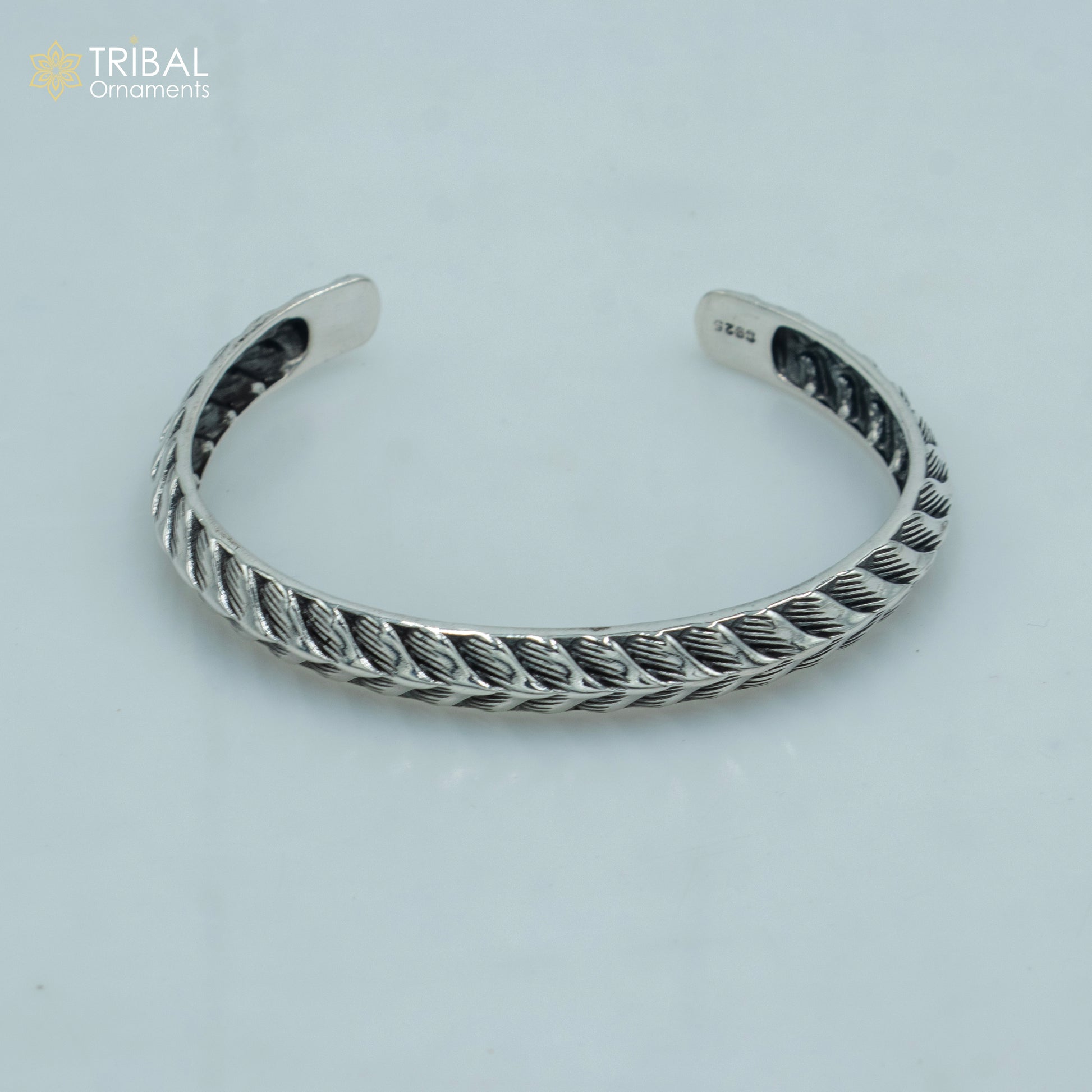 Sterling silver handmade adjustable bangle bracelet by TRIBAL ORNAMENTS, stylish unisex jewelry cuff with intricate design.